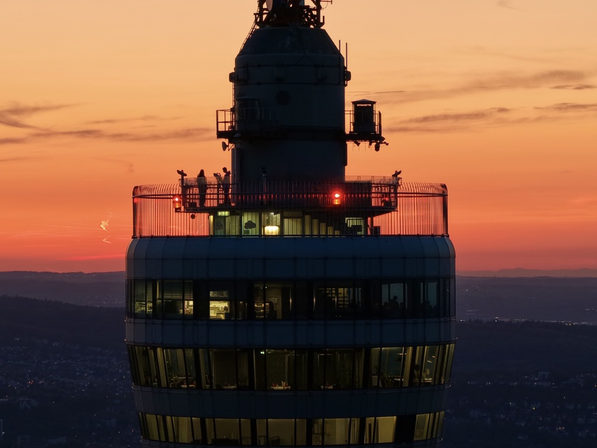 Silhouette einer Turmkanzel vor orangefarbenem Abendhimmel